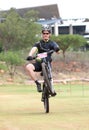 Happy middle aged man popping wheelie at the finish line at Mountain Bike Race